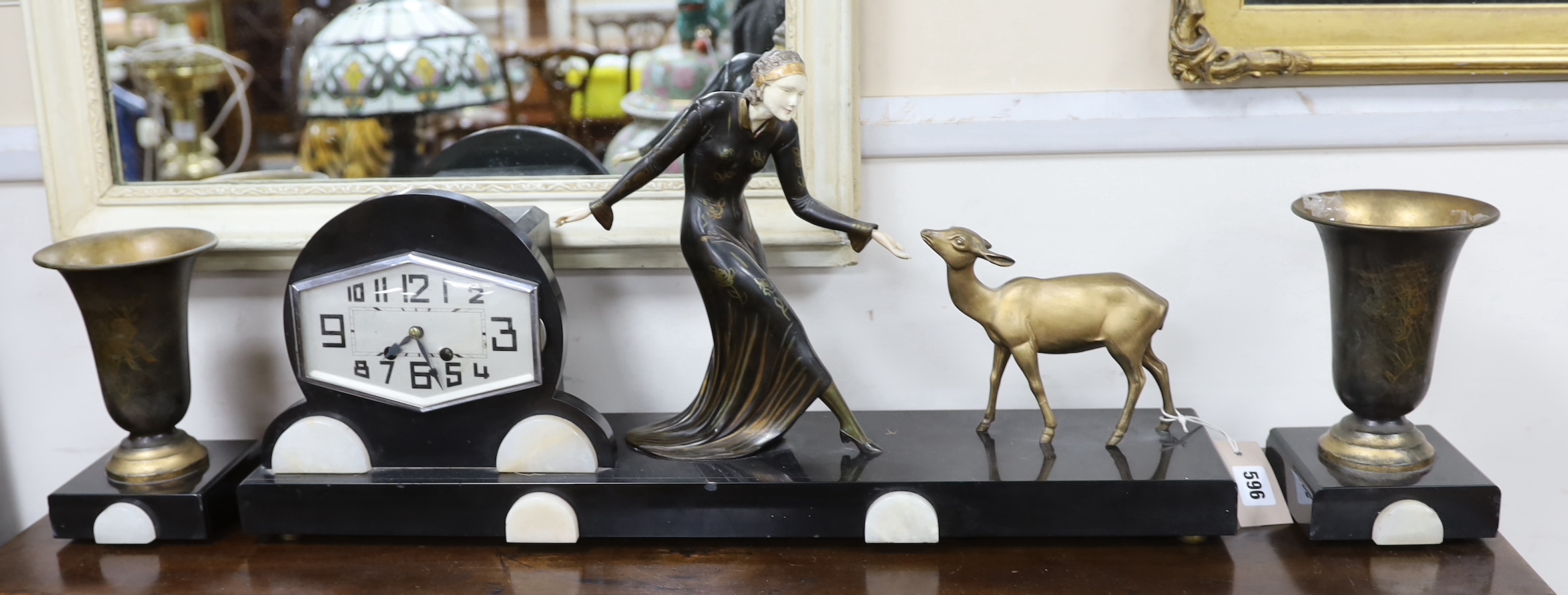 An Art Deco style bronze and ivorine figural mantel clock garniture, 64cm wide excluding garnitures